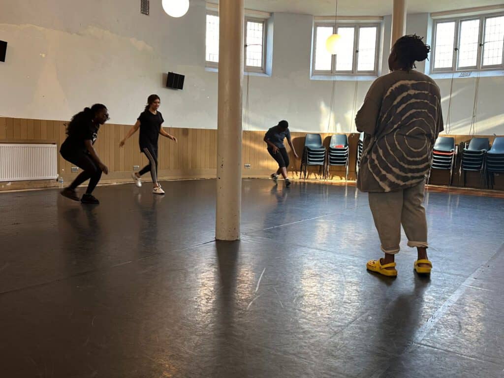 Jump rope fitness class with diverse participants in a spacious, well-lit indoor studio.