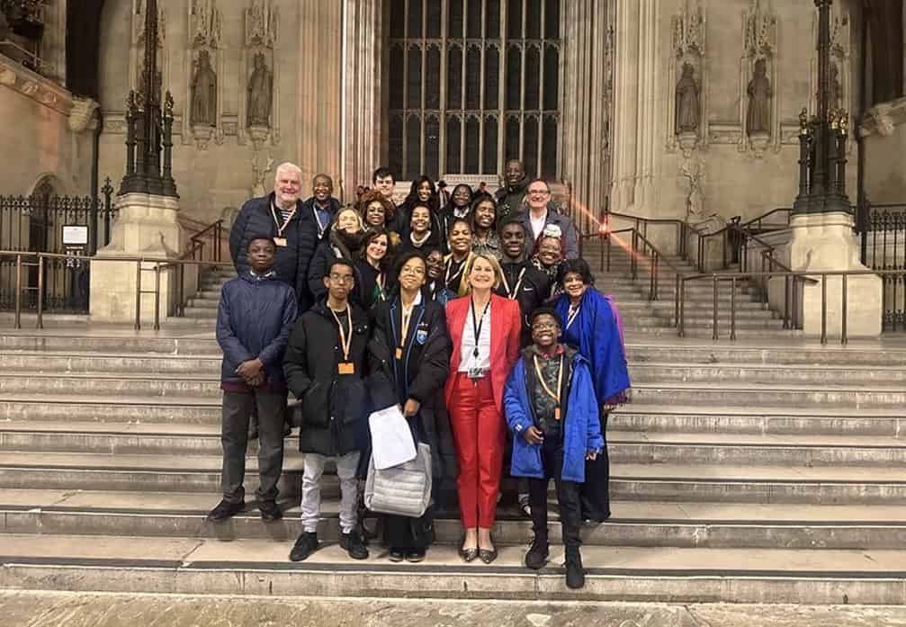 Diverse group of people standing on church steps during a conference or event.
