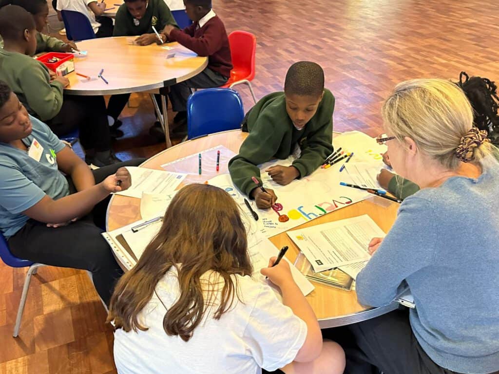 Engaging classroom activity with diverse students and teacher collaborating on educational projects.
