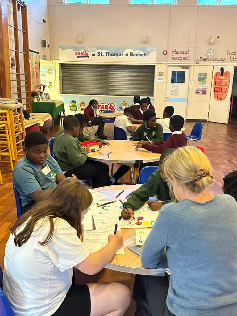 Children engaging in educational activities in a classroom setting at C4CWB.